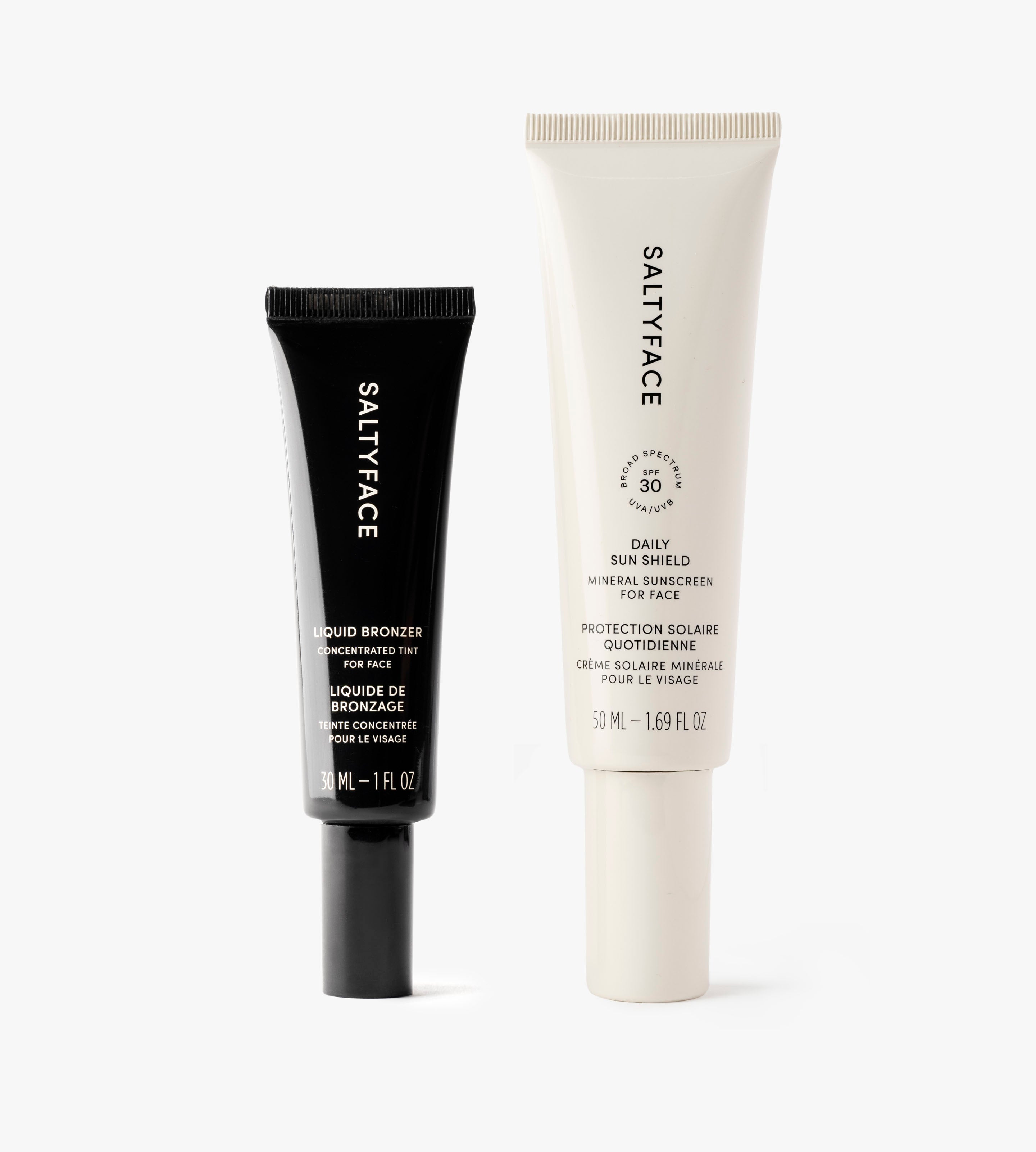 Sunscreen & Bronze products—a mineral face sunscreen with SPF 30 in a white tube and a liquid bronzer in a black tube—stand side by side on a white background.