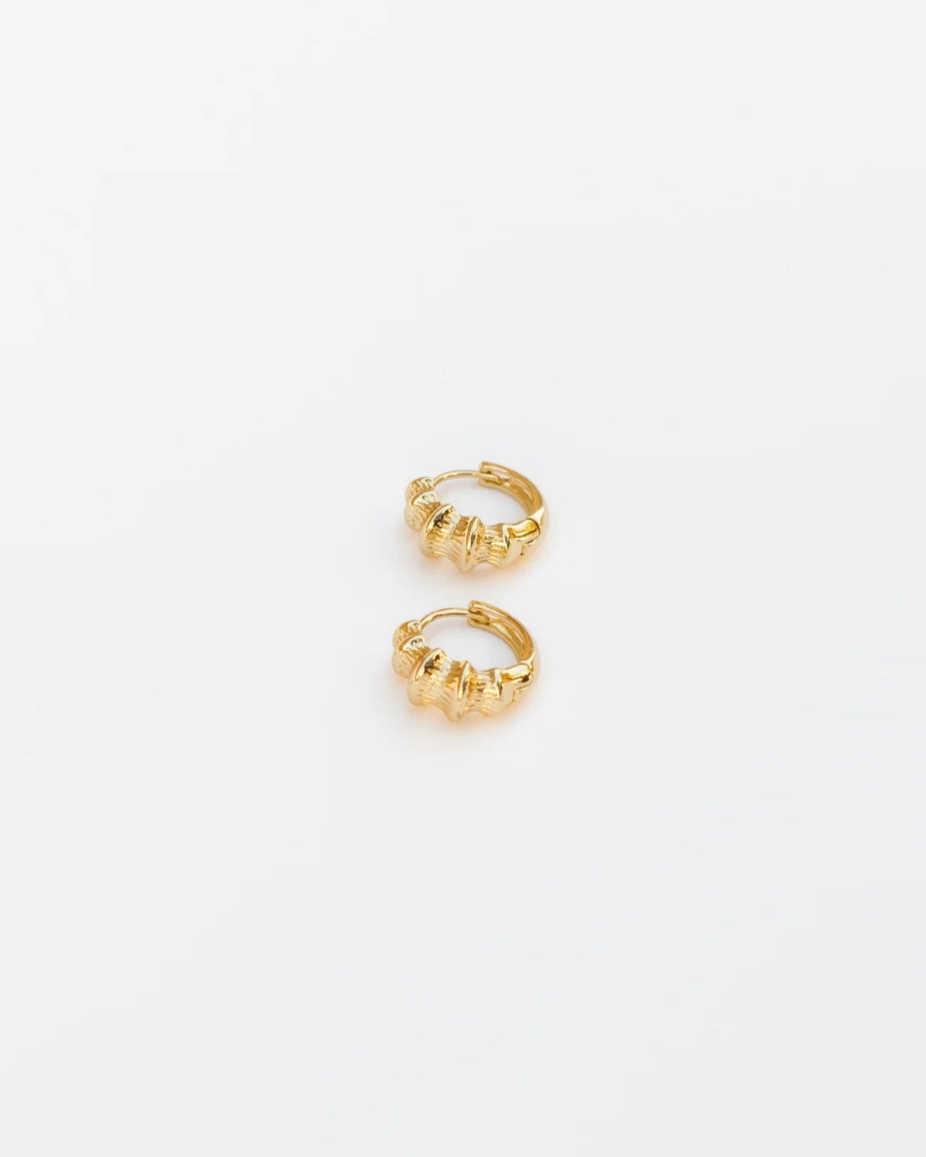 Pair of gold hoop earrings on a white background